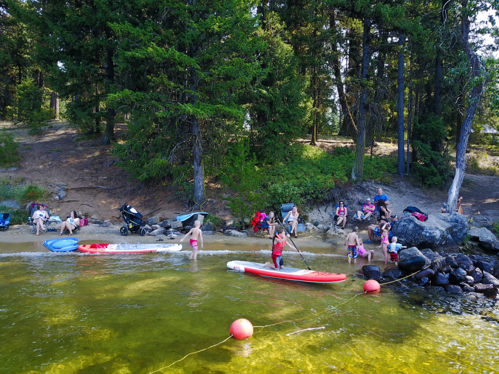 Families enjoy the beach and water at Peninsula Campground off of Payette Lake in McCall Idaho.