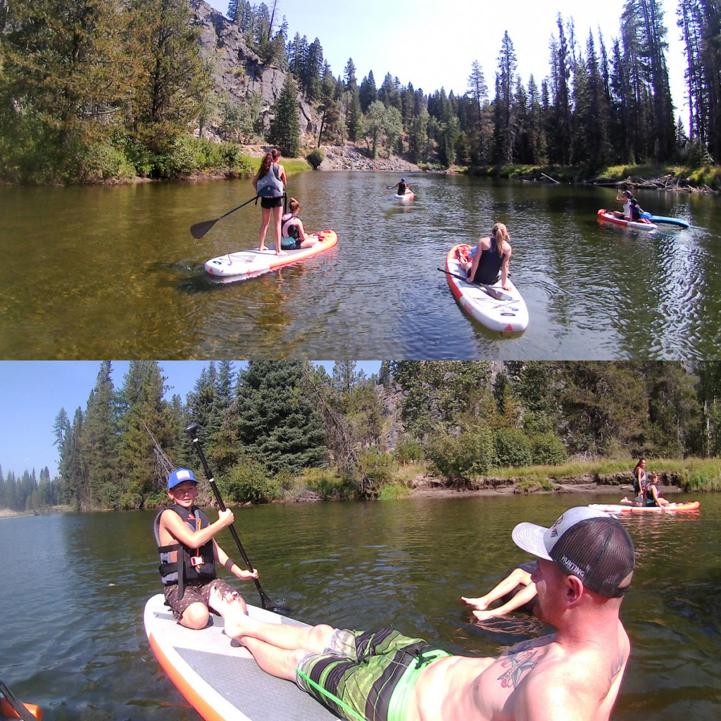 A Family paddle boards in McCall Idaho on the river leading into Payette Lake. 